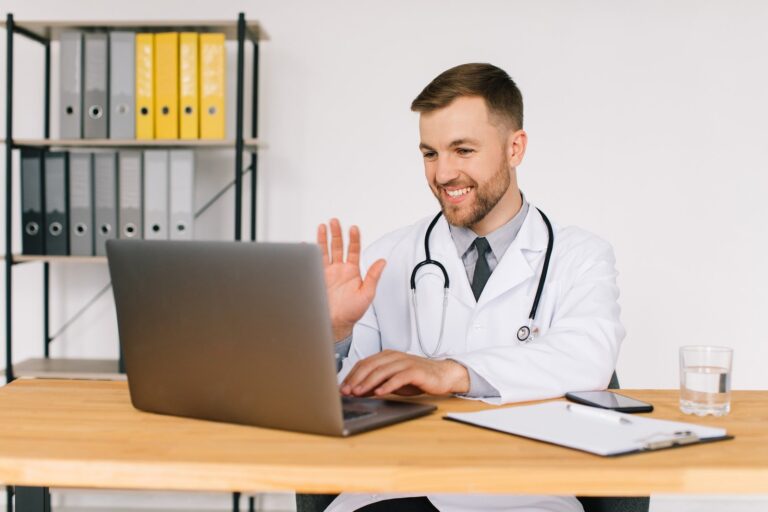 Happy male doctor watching an online medical webinar or training seminar